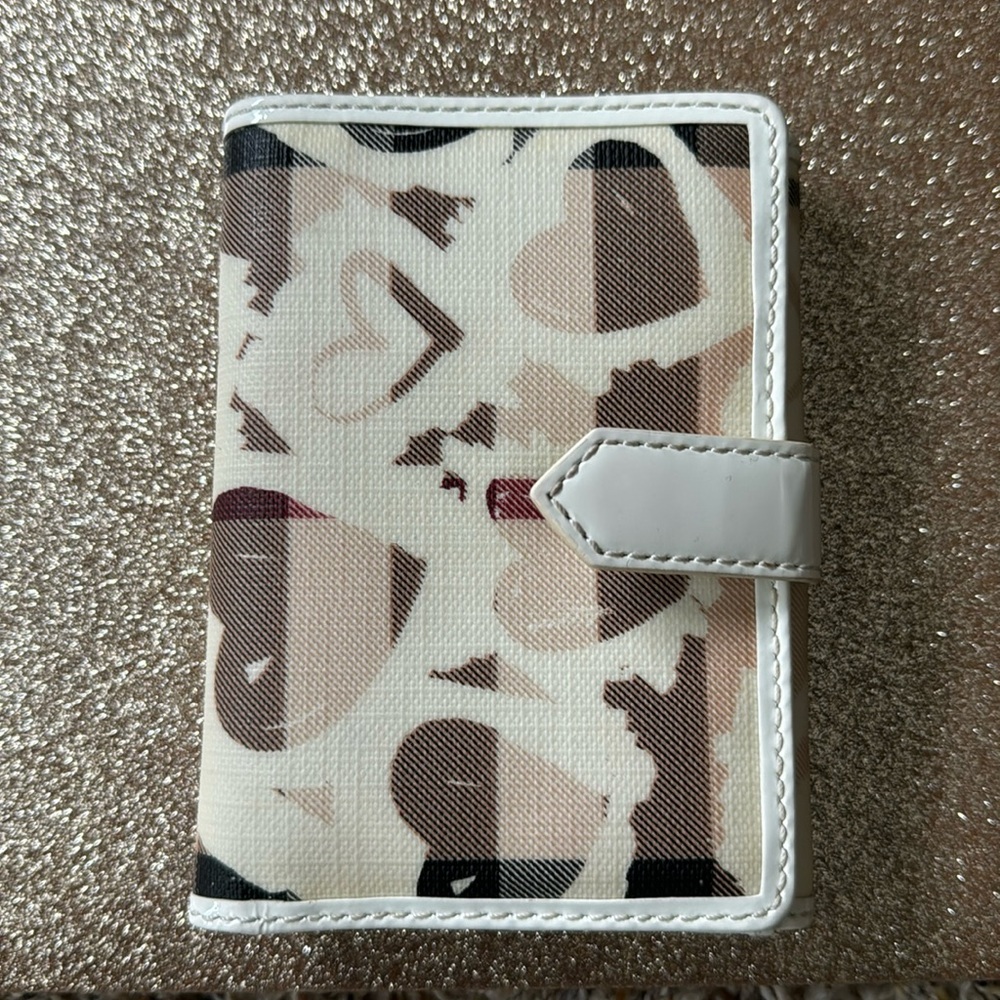 Pre-owned authentic Burberry heart pattern wallet.